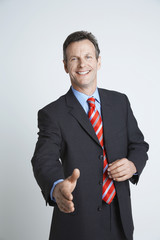 Portrait of a happy offering handshake isolated over white background