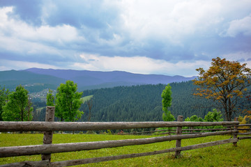 Fototapeta na wymiar wooden fence in the mountains summer day