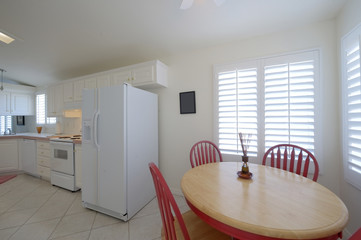 Classic kitchen with dining table with red chairs