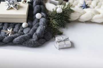 Fototapeta na wymiar Gift with Christmas decoration and knit blanket