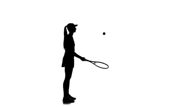 Tennis in the sports form fills racket ball. Silhouette. Slow motion