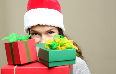 Beautiful happy woman with Christmas gifts on color background