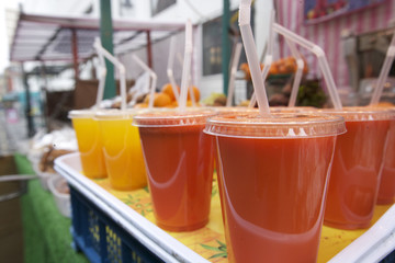 Close-up of fruit juices on display at market stall