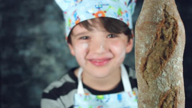 4k Colourful Shot of a Cook Child Showing Ciabatta Bread at Camera