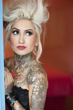 Tattooed young woman looking away