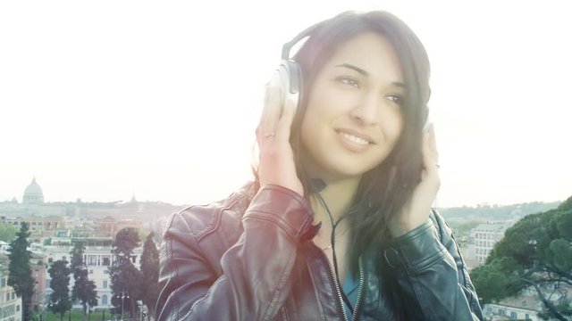 young happy woman listening music with headphones