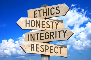 Wooden signpost with four arrows - ethics, honesty, integrity, respect - great for topics like...