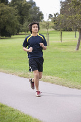 Young Chinese man jogging at park