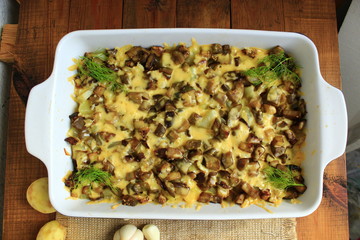 stewed potatoes with slices of eggplant under melted cheese and garlic