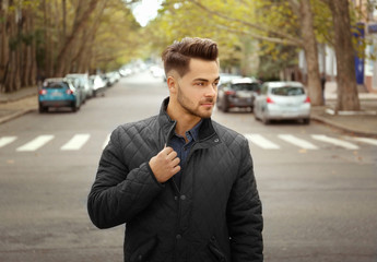 Handsome man on street background