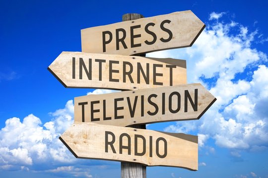 Wooden signpost with four arrows - press, Internet, television, radio - great for topics like media, communication etc.