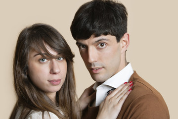 Portrait of a young Hispanic couple over colored background