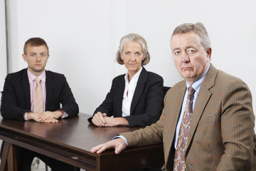 Fototapeta premium Portrait of confident business group at desk in office