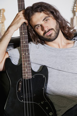 Portrait of young man holding guitar