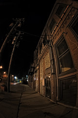 Fototapeta na wymiar Dark City Sidewalk and Building at Night