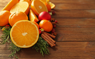Composition of citruses and spices on wooden background, closeup