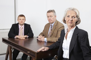 Portrait of confident business group at desk in office