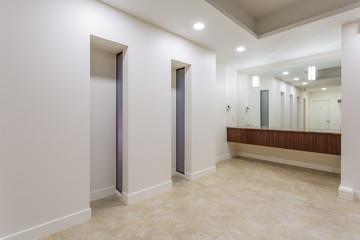 Spa or sauna modern bathroom with shower, white sinks and stone counter top.