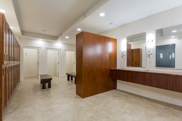 Newly built modern dressing room with lockers and benches for sitting.