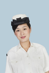 Portrait of a beautiful young US Navy officer over light blue background