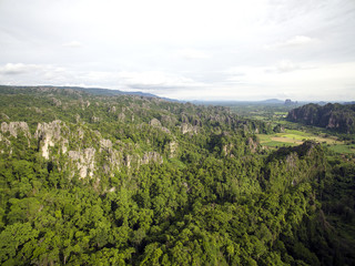 Obraz premium Aerial view of limestone mountain Karst, the Avatar-like mountain pass of sharp cliffs, peak forest and sinkhole landscape made up of carbonate rocks, Devonian limestone