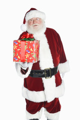 Portrait of a Santa Claus holding gift box isolated over white background