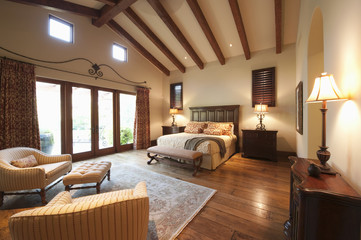 Spacious bedroom with beamed wooden ceiling