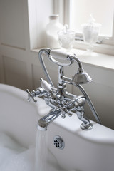 Shower fitting with running tap in bathroom