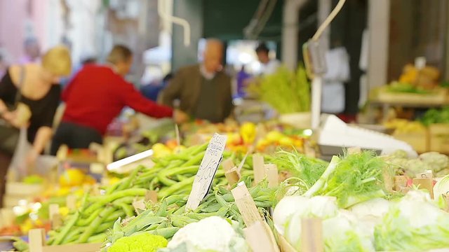 at the market place: stands selling vegetables