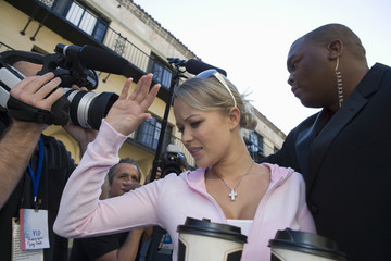 Closeup of a female celebrity and paparazzi