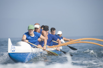 Multiethnic outrigger canoeing team in race