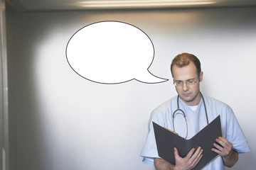 Mid adult male surgeon reading medical report with thought bubble