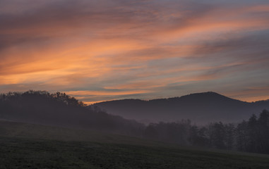 Sunrise under Milesovka hill in winter