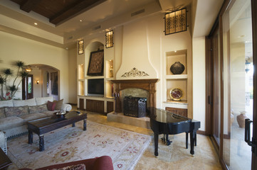 View of a spacious living room with baby grand piano at home
