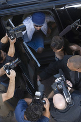 Elevated view of paparazzi around male celebrity