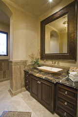 Dark brown bathroom unit with leather mirror frame