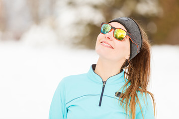 Winter workout. Girl wearing sportswear and sunglasses.