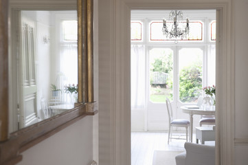 Mirror in hallway with view of living room