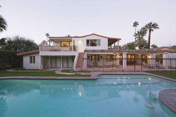 Swimming pool and modern home exterior against clear sky