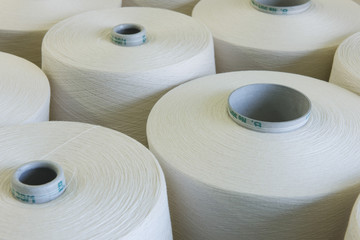 Detail shot of thread spools in spinning factory - Powered by Adobe