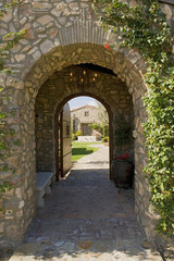 Fototapeta na wymiar View of arched walkway with open door