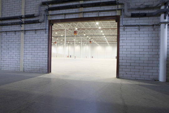 Access door to brightly lit and empty storehouse
