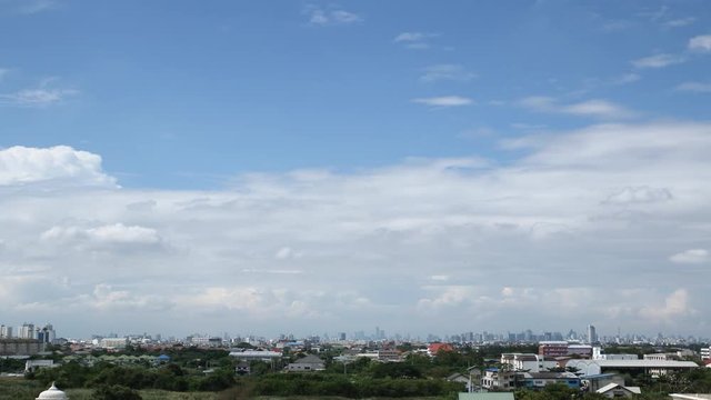 Fluffy white clouds on sky with moving in cityscape,Time Lapse