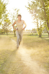 Full length of man listening music while running in park