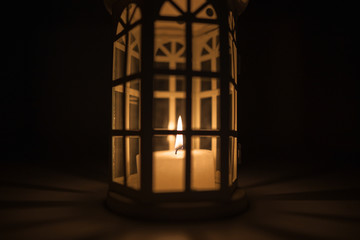 lantern with a candle in a dark background