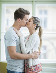 Passionate couple kissing in house