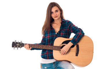 stylish brunette girl playing guitar