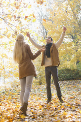 Full length of couple enjoying in autumn