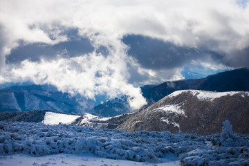 Fototapeta na wymiar White clouds in the winter mountains.