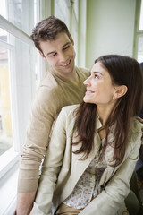 Obraz premium Happy romantic couple looking at each other at home